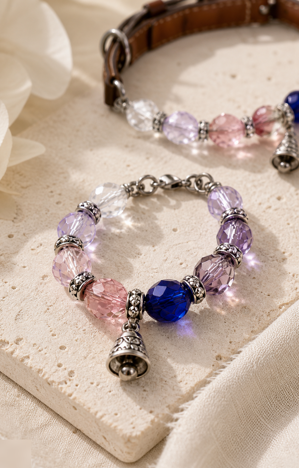 Matching human bracelet crystal bead and bell charm detail